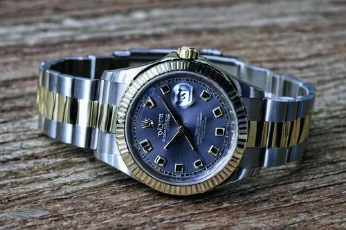 Write a short story about a Rolex watch that holds a mysterious power.,rolex,vintage watch,gold watch,tudor,men's watch,dark blue and gold,male watch,the bezel,timepiece,chronograph,open-face watch,wr