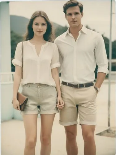 Create an elegant hand-holding couple in shorts that will show off your best work.,a man and woman stand next to each other,vintage man and woman,lakorn,vintage boy and girl,model years 1960-63,kenned