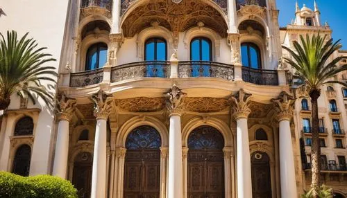 Spanish Modernism architecture, grandiose entrance, intricate stone carvings, ornate ironwork, curved lines, domed roof, asymmetrical facade, vibrant ceramic tiles, stained glass windows, imposing col