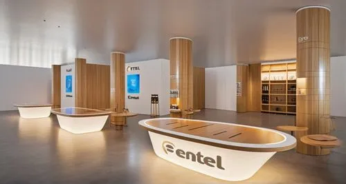 The product stand of the art fancy brand 'Fentel'. Products are displayed on the stand with Fentel's logo on it. Each pillar is surrounded by a chair and the wall is displayed with mechanical pencils 