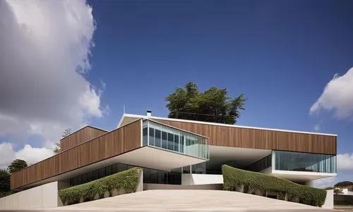 A commercial building with a square on the ground floor, built with a metal structure, concrete, realistic glass, tropical vegetation, parking for cars, interlocking concrete floor, style by Brazilian