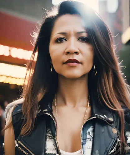 Woman with long hair,background bokeh,asian woman,santana,chinatown,city ​​portrait,asian,asian vision,china town,vietnamese woman,peruvian women,leather jacket,video scene,super heroine,superhero bac