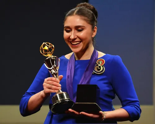 Describe Tatiana Shaykhlislamova's joyous reaction to winning a prestigious award.,award ceremony,award,social,honor award,azerbaijan azn,rosa khutor,awards,miss circassian,award background,nobel,beya