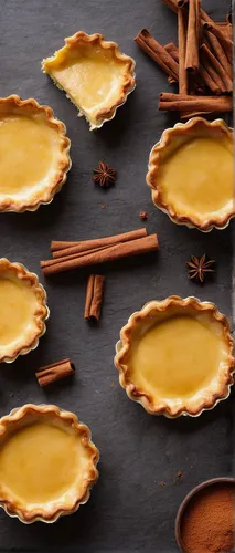 in a cozy bakery, create cream cheese tarts with a hint of cinnamon,sweet potato pie,pumpkin pie,graham cracker crust,yellow leaf pie,shortcrust pastry,pumpkin pie spice,chocolate tarts,cream cheese t