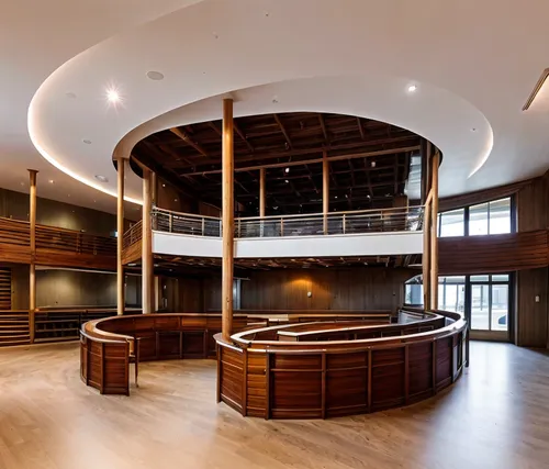 interior shot with ramp around open foodcort there is theatre in the background , wooden floors and white celling , the ramp handrail is glass , use warm lights,conference room,lecture hall,billiard r