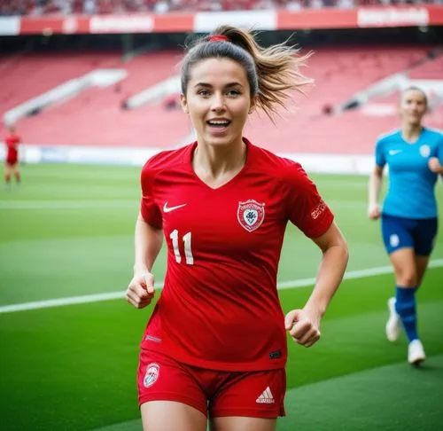 Same person wearing soccer cleats, soccer socks, soccer pants. she has abs. She scored a goal on a soccer pitch and celebrating by holding her red soccer jersey in her hand. she is wearing her bra. sh