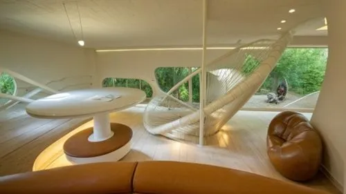 Temporary ecological residence project inspired by snail form
The space inside the residence,a modern living room with a hanging hammock,superadobe,dunes house,ufo interior,seidler,interior modern des