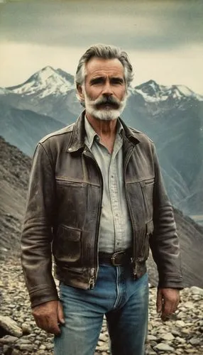 craggy faced, mature man, strong facial features, wrinkles, deep lines, rough skin texture, gray hair, beard, mustache, rugged clothing, leather jacket, worn jeans, boots, standing, mountain peak, clo