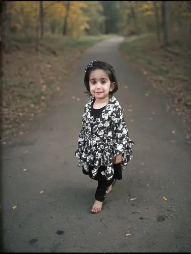 a little girl standing in front of a tree filled forest,reema,little girl running,grandniece,autumn photo session,little girl twirling,ballerina in the woods,sarhadi,hanania,toddler in the park,maryam