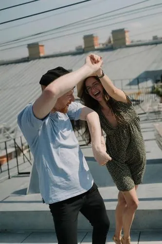 Two people dancing on a rooftop terrace,on the roof,roof top,rooftops,rooftop,athletic dance move,pre-wedding photo shoot,roof,dance with canvases,latin dance,photo shoot for two,piggyback,picture ide