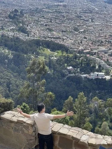 a man is looking at the scenic view from the hill top,rubidoux,ehden,duhok,queretaro,klis,cuernavaca,cahuenga,lycabettus,bikfaya,above the city,angeleno,altadena,zgharta,pena de bernal,baabda,guanajua