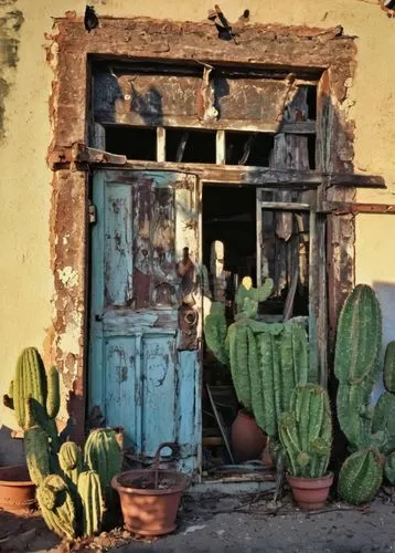 Abandoned architectural salvage yard, Tucson, Arizona desert, old worn-out doors, vintage windows, rusty metal gates, wooden planks, broken ceramics, distressed stone walls, southwestern style, adobe 