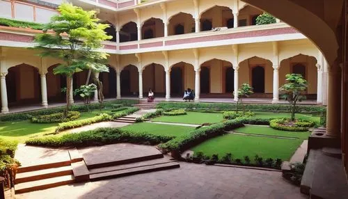 Modern Indian architecture school, college campus, beautiful courtyard, lush greenery, traditional Indian style building with modern twists, intricate stone carvings, large windows, natural light, woo