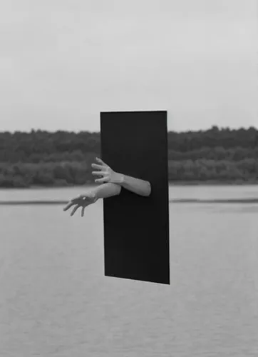 holding a frame,klaus rinke's time field,unreality,black squares,rectangles,conceptual photography,black landscape,cube surface,clip board,cube sea,paperboard,counting frame,illusion,enlarger,box came