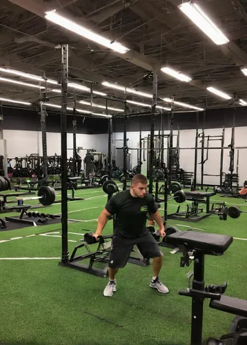 Concord High School strength and conditioning,strength athletics,overhead press,strength training,weight training,precision sports,free weight bar,weight lifting,squat position,fitness center,circuit 