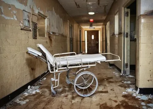 Abandoned hospital building, worn-out walls, rusty medical equipment, dimly lit corridor, eerie atmosphere, cracked floor tiles, old X-ray machines, broken wheelchairs, faded nurse uniforms, dusty med