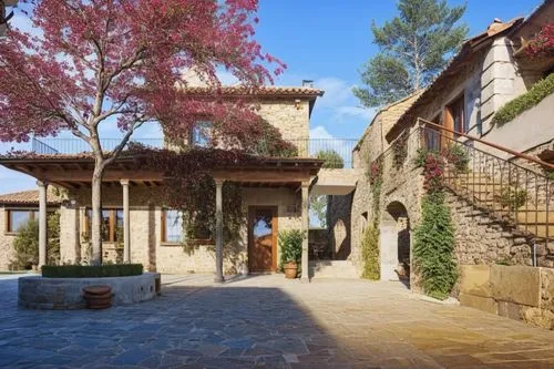 a couple of stone buildings with pink trees and some shrubs,casabella,provencal,cyaxares,provencal life,ehden,luberon,Photography,General,Realistic