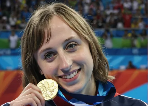 Aug. 12, 2016: United States' Katie Ledecky shows off her gold medal in the women's 800-meter freestyle medals ceremony during the swimming competitions at the 2016 Summer Olympics in Rio de Janeiro, 