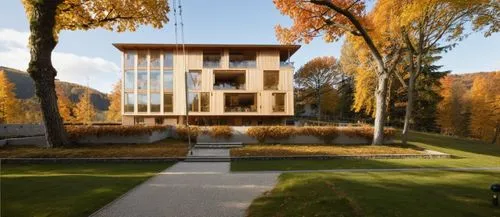 a wooden and glass building with autumn foliage around it,cubic house,zumthor,passivhaus,eisenman,lohaus,timber house,architektur,architekten,chancellery,kornhaus,archidaily,kundig,jermuk,modern house