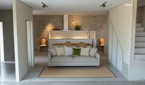 a frame living room, with concrete floor  and lime washed stone wall as a backdrop,habitaciones,showhouse,modern room,home interior,contemporary decor,annexe,appartement,inmobiliaria,guest room,modern