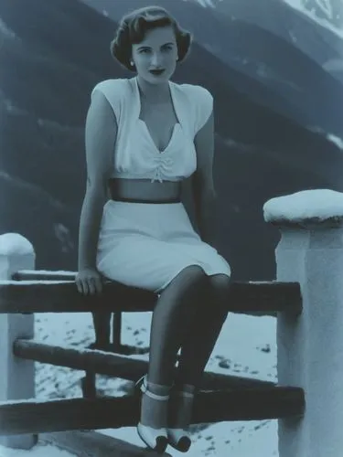 A lady from the 1940s in front of an Alpine backdrop.,the lady is sitting on a bench wearing her white skirt,ingrid bergman,jane russell-female,stanwyck,teresa wright,myrna,maureen o'hara - female,Pho