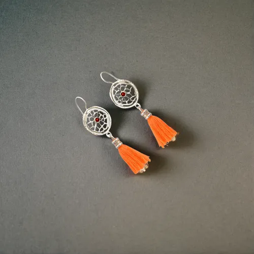 two earrings lie on a white background, top view of the earrings,compasses,hairpins,cufflinks,cufflink,pushpins,push pins,fidget toy,x-wing,traffic cones,clothe pegs,climbing equipment,two pin plug,ro