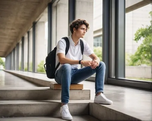 Architecture student, young adult, 20s, casual wear, jeans, white shirt, sneakers, backpack, sitting, standing, walking, campus, university, modern building, concrete structure, large windows, greener