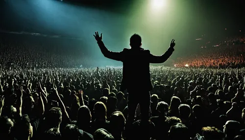 Imagine being amidst a sea of dedicated fans, feeling the pulsating energy and raw emotions at a NIN concert.,concert crowd,raised hands,rock concert,live concert,concert,audience,worship,conducting,a