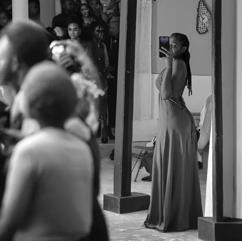girl in a long dress from the back,a girl with a camera,paparazzi,girl in a long dress,woman holding a smartphone,taking pictures,taking photos,photographing,paparazzo,wedding photographer,taking photo,taking picture,long dress,street photography,strapless dress,young model istanbul,girl walking away,girl from the back,mannequin silhouettes,outside mirror