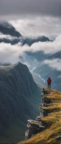 person standing near the edge of a mountain near clouds during day,scottish highlands,mountaineering,faroe islands,mountain guide,trolltunga,highlands,three peaks,scotland,mountaineer,mountain tundra,