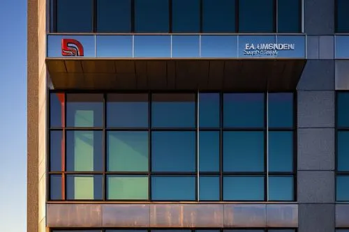 Industrial building, modern architectural style, large windows, steel frame, glass panels, reflective surface, urban cityscape, morning light, soft shadows, shallow depth of field, 3/4 composition, wa