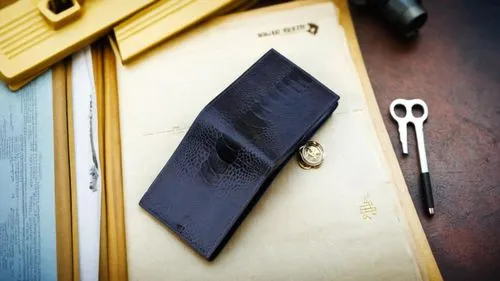 a blue wallet placed  upside down,a leather wallet and some tools sitting on top of a table,clip board,daguerreotype,daguerreotypes,pin board,picture frame,ambrotype