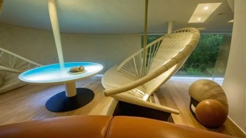 Temporary ecological residence project inspired by snail form
The space inside the residence,an oval table sits in the center of a living room,seidler,casa fuster hotel,interior modern design,winding 