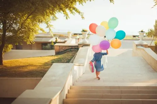 little girl with balloons,colorful balloons,rainbow color balloons,corner balloons,girl walking away,balloons,pink balloons,balloons mylar,woman walking,blue balloons,balloons flying,heart balloons,re