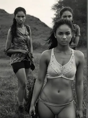 Black and white high resolution drawing: The female soldiers walk side by side and appear relaxed, despite being in a military environment. They exchange warm smiles, showing their close friendship an