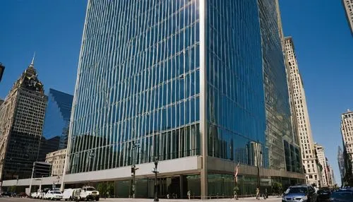 Modern skyscraper, AIA headquarters, daytime, clear blue sky, sleek glass façade, angular lines, steel beams, grand entrance, revolving doors, marble lobby, elegant chandeliers, busy streets, urban la