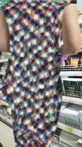 a person holding onto a very colorful knitted fabric,jogbra,autism infinity symbol,rayon,kaleidoscopic,vpl,woven