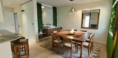 dining table sofa and chairs with a floating vanity unit having full length mirror with green climbing plants on both sides and a pendant style chandelier above, wall are white in color with photo fra