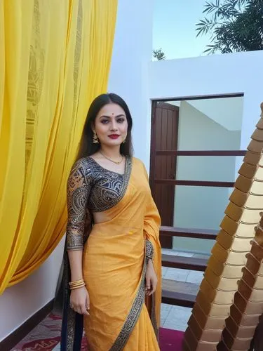 an indian girl in a yellow sari posing for the camera,jayaprada,namitha,saree,sari,ramya,paithani saree