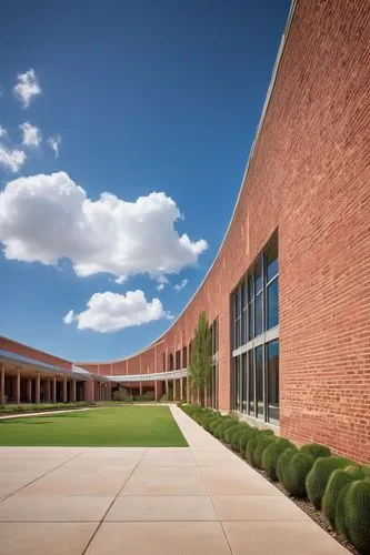 Modern university building, Texas style, Architectural Engineering Department, red brick walls, white columns, large glass windows, sloping roofs, detailed stonework, sprawling campus, vibrant greener