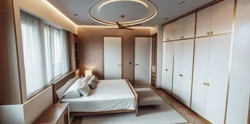 Bedroom with modern interior, decorative modern false ceiling, 4 door wardrobes opposite bed, wall art with lights and the door facing the camera leading into the bathroom and another next to the ward