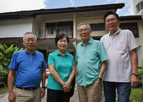 Ms Susan Tong (second from left) and her husband David Koh (third from left), a 57-year-old retiree, outside their corner terrace house in Yio Chu Kang, with the second of their three sons, Lionel (ex