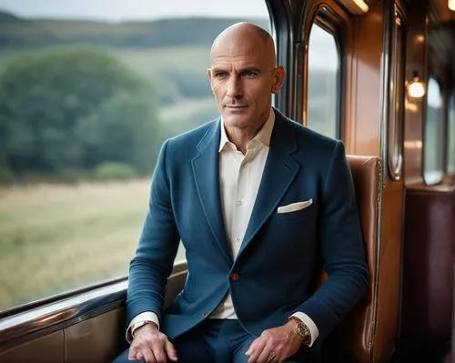 The large gentleman in the train carriage (movie character),a man wearing a suit sitting on top of a train,ebdon,davydenko,dallaglio,balmont,ljungberg,balcomb,Photography,General,Cinematic