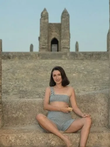 man and woman posing in front of an ancient building,a woman sitting on steps in front of a castle,zinta,jadzia,oreiro,letizia,seoige,isinbayeva,Photography,Black and white photography,Black and White