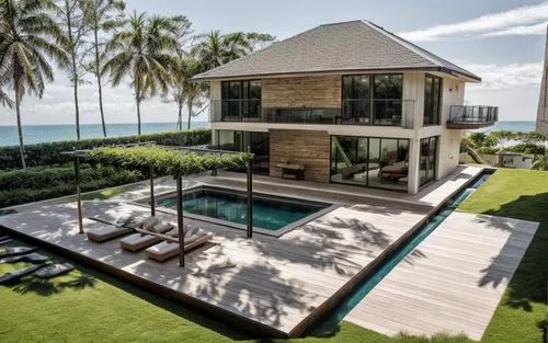 An ultra-luxurious villa with the Maldives shoreline and lush forests in the background.,a pool surrounded by lots of trees on a lush green field,oceanfront,holiday villa,beach house,luxury property,b