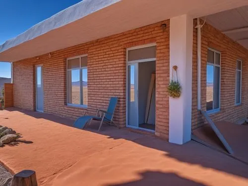 there is a covered patio with some chairs,coober pedy,coober,san pedro de atacama,dunes house,meekatharra,oodnadatta,Photography,General,Realistic