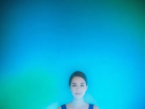 a beautiful woman in black dress standing in blue room,turrell,blue background,blue light,green screen,blue gradient,hologram