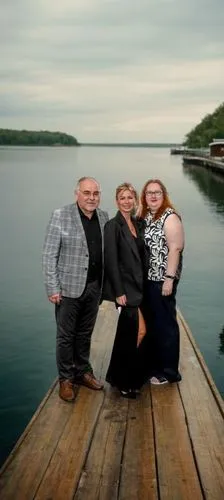 three people are posing for a picture on a wooden pier,loughinisland,family pictures,wedding photo,guysborough,ferryland,arichat