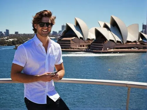 Australian male, bachelor, 25yo, casual wear, white shirt, blue jeans, black sunglasses, messy brown hair, holding a large portfolio, standing, relaxed pose, one hand in pocket, smiling, Australia, Sy