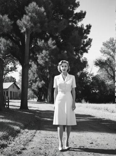 Historical scene in Texas,black and white pograph of woman in dress standing on dirt road,pleasantville,woman walking,mitford,reynolda,girl walking away,marylin monroe,Photography,Black and white phot